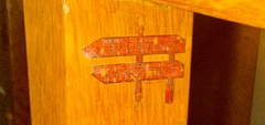 "L. & J.G.Stickley, Handcraft" decal shopmark / signature.  Circa 1906-1912. Located inside the true right leg and just under the lower drawer support. 
This image was taken with camera flash, explaining the brighter color.                   